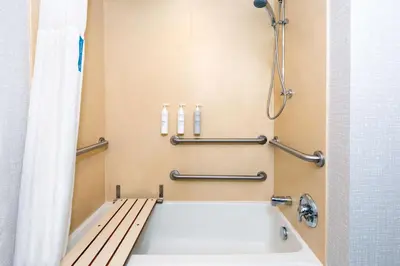 a bathroom with a bath tub and a shower at Hampton Inn and Suites Hartford/Farmington in Farmington