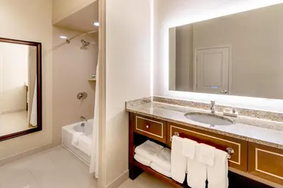 a bathroom with a sink and a mirror at New Haven Hotel in New Haven