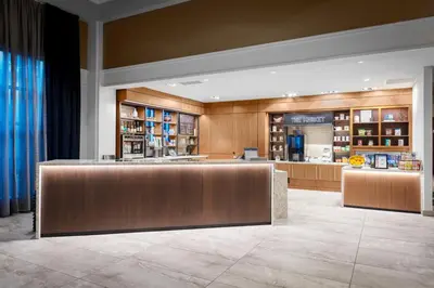 a hotel lobby with a bar and a pharmacy at New Haven Hotel in New Haven