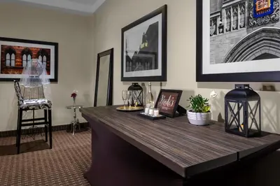 a desk in a room with a chair and pictures on the wall at New Haven Hotel in New Haven