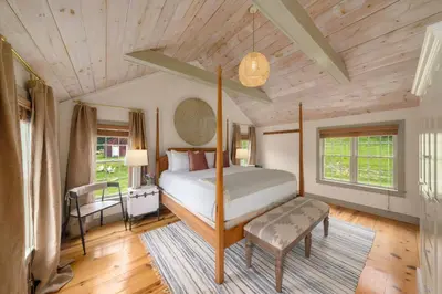 a bedroom with a bed and a wooden ceiling at Inn at Silver Maple Farm in East Chatham