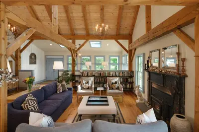 a living room with blue couches and a fireplace at Inn at Silver Maple Farm in East Chatham
