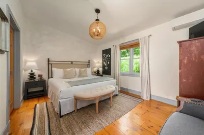 a bedroom with a large bed and a window at Inn at Silver Maple Farm in East Chatham