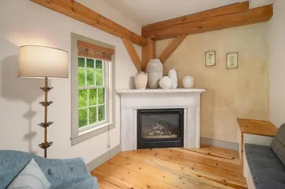 a living room with a fireplace and a couch at Inn at Silver Maple Farm in East Chatham