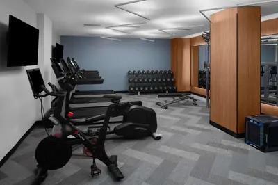 a gym with bikes and exercise equipment in a room at Hilton Brooklyn New York - Newly Renovated in Brooklyn