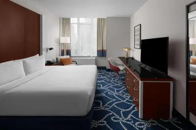 a hotel room with a bed and a flat screen tv at Hilton Brooklyn New York - Newly Renovated in Brooklyn