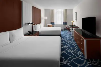 a hotel room with two beds and a flat screen tv at Hilton Brooklyn New York - Newly Renovated in Brooklyn