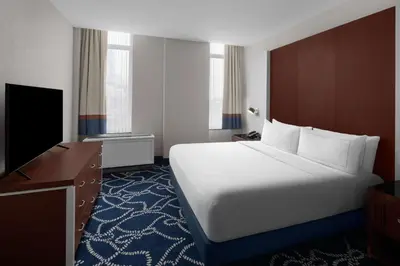a hotel room with a large bed and a flat screen tv at Hilton Brooklyn New York - Newly Renovated in Brooklyn