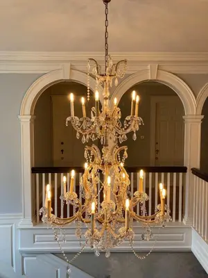 a chandelier with candles in a room at The White House Inn in Wilmington