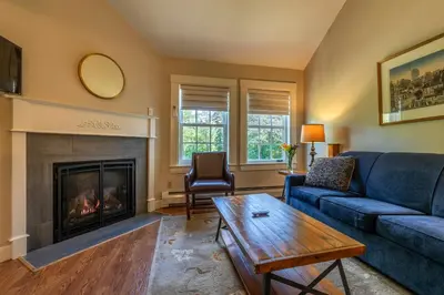 a living room with a couch and a fireplace at The White House Inn in Wilmington