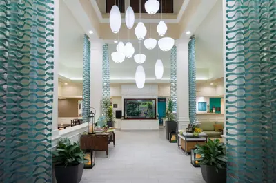 a lobby of a hospital with tables and chairs at Hilton Garden Inn Hartford South/Glastonbury in Glastonbury