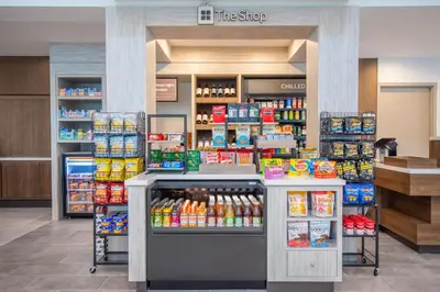 a grocery store with a aisle with food and drinks at Hilton Garden Inn Danbury in Danbury