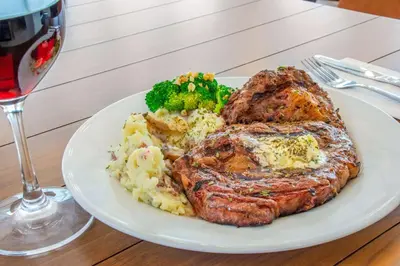 a plate of food with steak and potatoes and broccoli at Hilton Garden Inn Danbury in Danbury