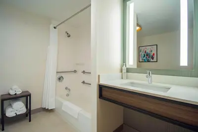 a bathroom with a sink and a tub and a shower at Hilton Garden Inn Danbury in Danbury