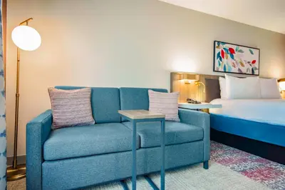 a living room with a couch and a bed at Hilton Garden Inn Danbury in Danbury