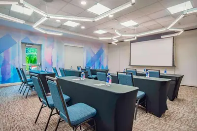 a conference room with tables and chairs and a whiteboard at Hilton Garden Inn Danbury in Danbury
