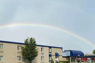 a rainbow in the sky over a building at Travelodge Inn & Suites by Wyndham Albany in Albany