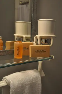 a shelf with some products on it in a bathroom at The Stables in Kingston