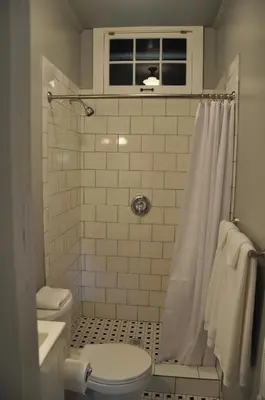 a bathroom with a toilet and a shower at The Stables in Kingston