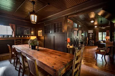 a dining room with a wooden table and chairs at The Stables in Kingston