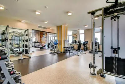 a gym with treadmills and machines in a building at Global Luxury Suites at Newport in Jersey City