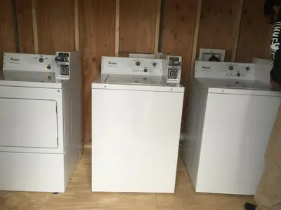 three washing machines sitting next to each other at Apple Inn and Suites Cooperstown Area in Milford