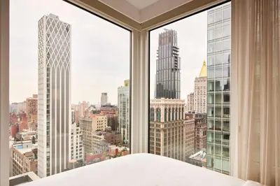 a bedroom with a view of the city at Arlo NoMad in New York