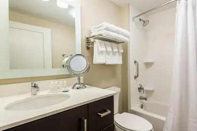 a bathroom with a sink and a toilet and a mirror at TownePlace Suites by Marriott Latham Albany Airport in Latham