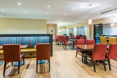 a dining room with tables and chairs at TownePlace Suites by Marriott Latham Albany Airport in Latham