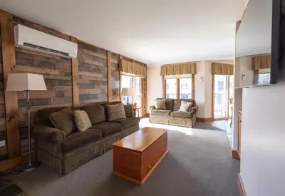 a living room with a couch and a table at Winwood Condominiums by Windham Mountain Club in Windham