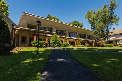 an exterior view of a building with a pathway at Winwood Condominiums by Windham Mountain Club in Windham