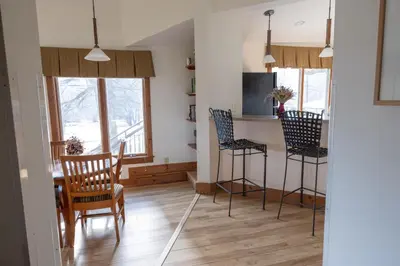a kitchen and dining room with chairs and a table at Winwood Condominiums by Windham Mountain Club in Windham