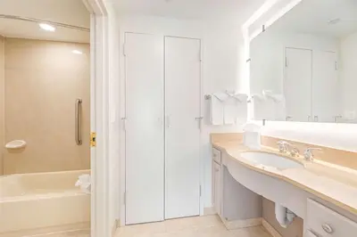 a white bathroom with a sink and a shower at Homewood Suites by Hilton East Rutherford - Meadowlands, NJ in East Rutherford