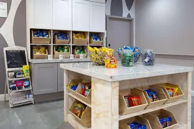 a kitchen with a counter with food on it at Ramada by Wyndham Hartford North - Bradley Airport in Windsor Locks
