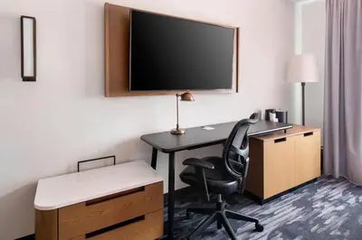 a room with a desk and a tv and a chair at Fairfield Inn by Marriott New York LaGuardia Airport/Flushing in Queens