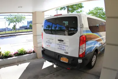 a white van parked in front of a building at Fairfield Inn by Marriott New York LaGuardia Airport/Flushing in Queens
