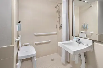 a white bathroom with a sink and a shower at Fairfield Inn by Marriott New York LaGuardia Airport/Flushing in Queens