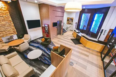 a lobby with a fish rug in the middle of a room at Fairfield Inn by Marriott New York LaGuardia Airport/Astoria in Queens