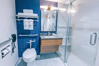 a bathroom with a toilet and a sink and a shower at Fairfield Inn by Marriott New York LaGuardia Airport/Astoria in Queens
