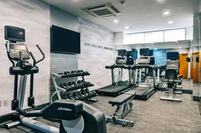 a gym with several treadmills and cardio machines at Fairfield Inn by Marriott New York LaGuardia Airport/Astoria in Queens