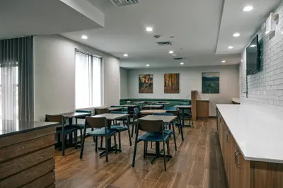 a dining room with tables and chairs at Fairfield Inn by Marriott New York LaGuardia Airport/Astoria in Queens