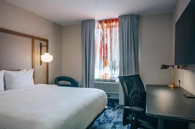a hotel room with a bed and a desk and a window at Fairfield Inn by Marriott New York LaGuardia Airport/Astoria in Queens