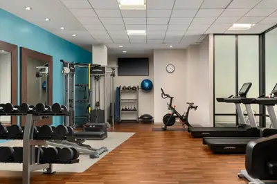 a gym with treadmills and machines in a room at DoubleTree by Hilton Hartford Downtown in Hartford
