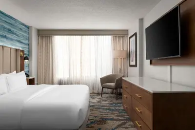 a hotel room with a large white bed and a chair at DoubleTree by Hilton Hartford Downtown in Hartford