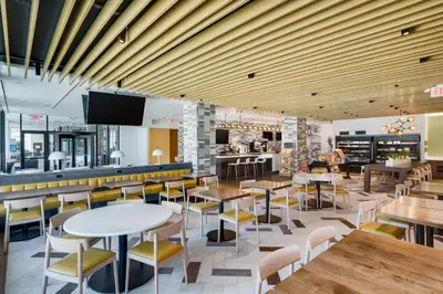a restaurant with tables and chairs and a bar at DoubleTree by Hilton Hartford Downtown in Hartford