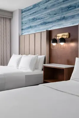 two beds in a room with two white beds at DoubleTree by Hilton Hartford Downtown in Hartford