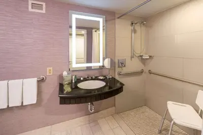 a bathroom with a sink and a mirror at The Saratoga Hilton in Saratoga Springs