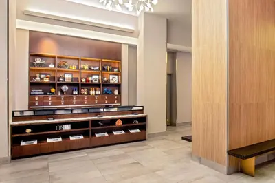 a lobby with a display case with china at Four Points by Sheraton Midtown - Times Square in New York