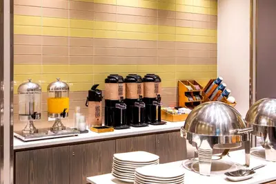 a kitchen with a counter with plates and coffeeences at Four Points by Sheraton Midtown - Times Square in New York