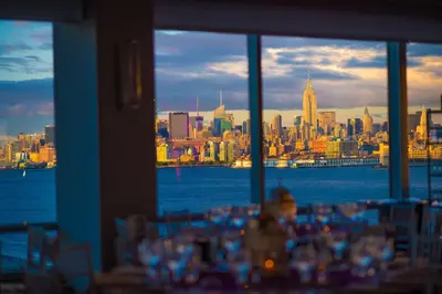 a table with a view of the city from a window at Hyatt Regency Jersey City on the Hudson in Jersey City